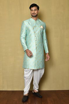 Green fancy jacquard sherwani with woven floral bootis. Comes with cream katan silk patiala.
Component: 2
Pattern: Woven
Type Of Work: Floral
Neckline: Mandarin collar
Sleeve Type: Full
Fabric: Fancy jaquard,katan silk
Color: Green
Other Details: 
Side overlap panel
Golden buttons
Welt pocket
Note: Pocket square worn by the model is not for sale
Occasion: Mehendi and Puja,Sangeet - Aza Fashions Festive Wedding Sherwani With Meenakari, Festive Sherwani With Meenakari And Traditional Drape, Fitted Traditional Brocade Wear With Meenakari, Designer Sherwani With Zari Weaving In Traditional Drape, Designer Sherwani With Zari Weaving For Eid, Designer Sherwani With Zari Weaving For Diwali, Festive Designer Sherwani With Zari Weaving, Traditional Festive Sherwani With Meenakari, Traditional Meenakari Sherwani For Eid