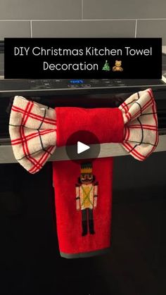 a kitchen towel holder with a bow tie hanging from it's side and the words diy christmas kitchen towel decoration