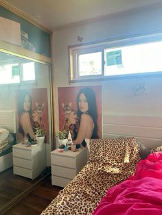 a bedroom with leopard print bedding and two pictures on the wall above the bed