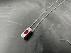 Our stunning men's jewelry pendant - a shiny, polished silver 925 square bar adorned with a captivating ruby gemstone. This necklace pendant is the perfect accessory to elevate any outfit.  Its sleek design and high-quality materials make it a timeless piece that will surely catch everyone's attention. DIMENSIONS - Pendant Width: 0.6cm - Pendant Length: 1.5cm MATERIALS 925 silver, ruby gemstone SHIPPING - Estimated shipping time: 7-14 business days (after processing) - Please take a moment to re Mens Jewelry Pendants, Future Board, Men's Necklaces, Square Bar, Mens Silver Necklace, Ruby Pendant, Ruby Jewelry, Polish Silver, Mens Pendant