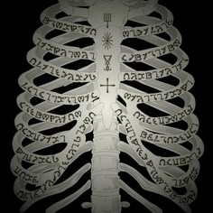 the ribcage with words written all over it in black and white, as well as a cross