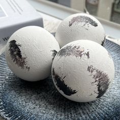 three white eggs sitting on top of a blue plate