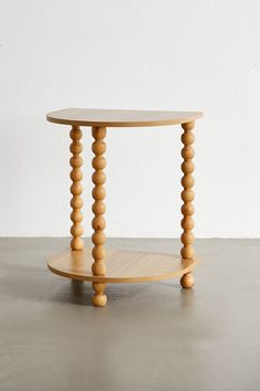 a small wooden table with two circular legs