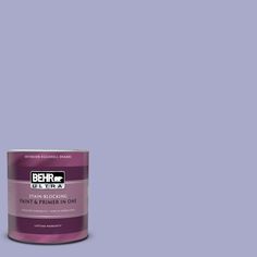 a can of behr paint on a green background