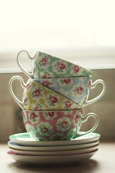 four cups and saucers stacked on top of each other