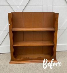 a wooden book shelf sitting in front of a garage door with the words before painted on it