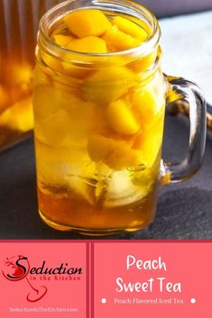 a jar filled with peach sweet tea sitting on top of a table