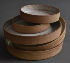 three brown bowls stacked on top of each other