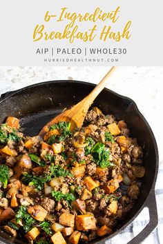 a skillet filled with meat and vegetables on top of a white table cloth next to a wooden spoon