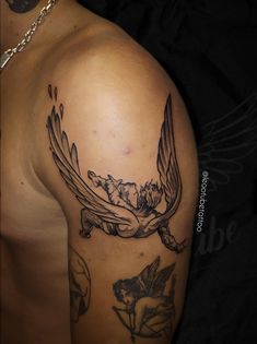 a man's arm with a tattoo on it that has a bird and flowers on it