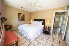 a bed sitting in a bedroom next to two lamps