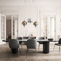 an elegant dining table and chairs in a white room