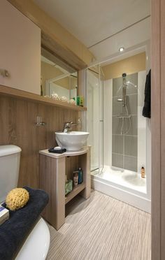 a bathroom with a sink, toilet and bathtub next to a walk in shower