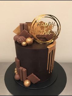 a chocolate cake with gold decorations on top