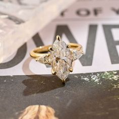 a diamond ring sitting on top of a magazine