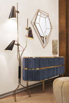 a living room with a blue cabinet and two black lamps on the wall next to it