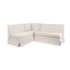 a white sectional couch with two pillows on it's back and the seat folded down