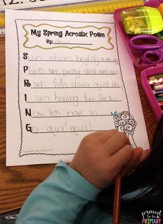 a young child is holding a pencil in front of a paper that says my spring acrostic poem