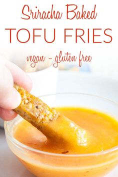 a hand dipping a piece of bread into a bowl of orange sauce with the words sricha baked tofu fries vegan - gluten free