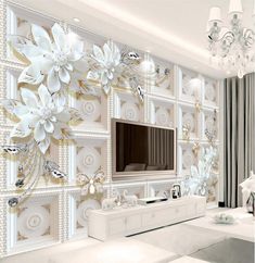 the living room is decorated in white and gold colors with flowers on the wall behind it