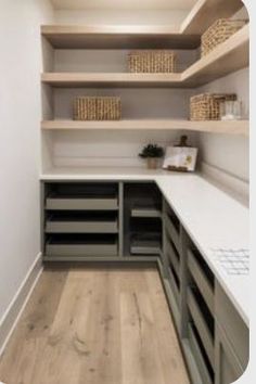 an empty walk in closet with shelves and drawers