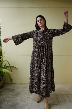 Late 60's, early 70's bell sleeved maxi dress in leopard print. Back zipper to close.  Bust: 40" Hips: 60" Length: 54" Circa: 1970's Condition: Fair vintage condition. This one was a labor of love. I had it re-hemmed and had stitching removed from the bust area (barely visible holes remain, but you have to look carefully). There are bleach spots throughout that kind of ate into the fabric (especially on the ends of the sleeves) and  scattered holes throughout. One sleeve is slightly longer than Dress Loungewear, Sleeved Maxi Dress, Hostess Dresses, Leopard Print Maxi Dress, Dress Vacation, Haute Hippie, Vacation Dresses, Maxi Dress With Sleeves, Printed Maxi