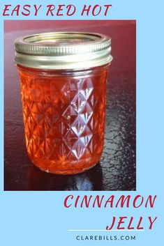 an easy red hot cinnamon jelly recipe in a mason jar with text overlay that reads easy red hot cinnamon jelly