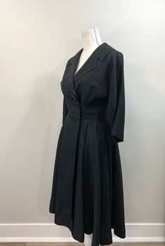 "Elegant black raw silk dress with great 1950s details. Lovely silhouette with one large button (and a bound buttonhole!) on the bodice as well as snaps and hooks inside. The collar and lapel are wide and fantastic. 3/4 dolman sleeve. Waist seam with pleats at the side front and back panels but flat in the front. The lining is a cheerful pale yellow silk. No label, handmade. Condition is great. The lining has some stains and discoloration as well as holes from wear and age under each underarm. R Vintage A-line Dress For Work, Retro Evening Dresses With Buttons, Formal Vintage Dress With Full Skirt, 1950s Vintage Dress With Buttons For Formal Occasions, 1950s Style Buttoned Dresses For Work, 1950s Style Vintage Dress For Work, 1950s Style Formal Dresses With Buttons, Vintage Evening Dress With Covered Buttons, Vintage Evening Dresses With Buttons