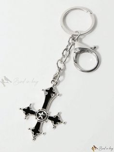 a black and silver cross keychain on a white background