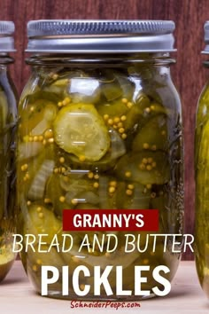 three jars filled with pickles sitting on top of a table