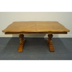 a wooden table sitting on top of a carpeted floor