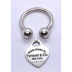 a heart shaped key ring with the words tiffany & co on it's side