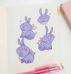 a drawing of three purple rabbits with wings and bows on their heads, sitting next to a pink pen