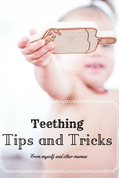 a woman holding up a piece of wood with the words teething tips and tricks