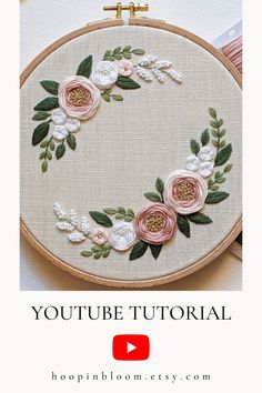 an embroidered hoop with flowers on it and the words, youtubee tutorial written in white