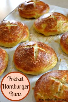 freshly baked pretzel hamburger buns on a baking sheet with text overlay