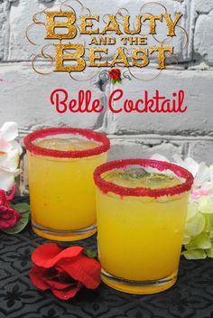 two glasses filled with yellow liquid and garnished with red glitter on the rim