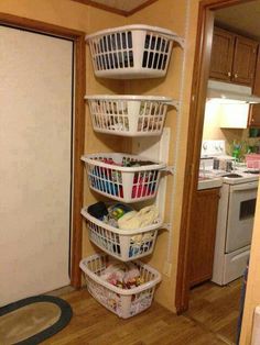 three baskets are stacked on top of each other in the corner of a kitchen area