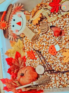 a white plate topped with corn and fall decorations