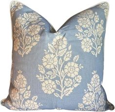 a blue pillow with white flowers on it