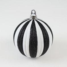 a black and white striped ball ornament on a white background with room for text