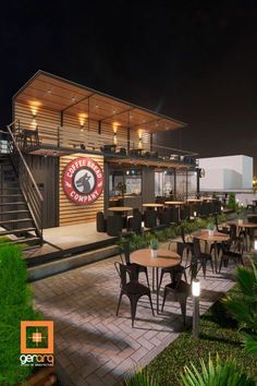 an outdoor restaurant with tables and chairs at night