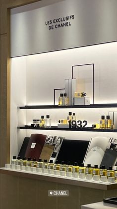 a display case filled with lots of perfumes and bottles on top of shelves next to each other