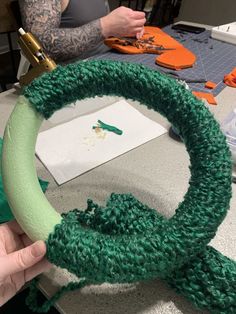 someone is making a wreath out of yarn