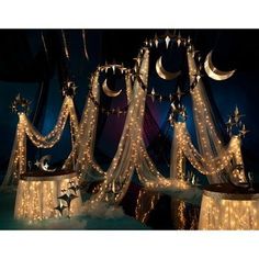 an image of a bed with lights and stars on it's headboard in the night