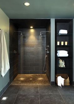 a walk in shower sitting inside of a bathroom