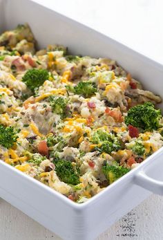 a casserole dish filled with broccoli, cheese and other toppings