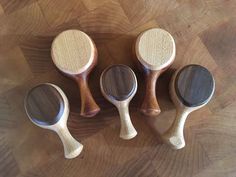 four wooden spoons sitting on top of a wooden table