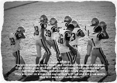 a group of young football players standing next to each other on top of a field