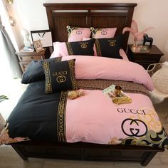 a bed with pink and black comforters in a bedroom